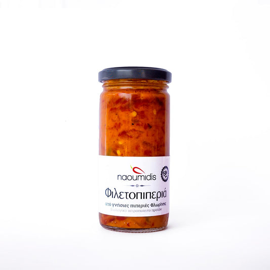 Jar of red pepper spread with a visible label on a white background